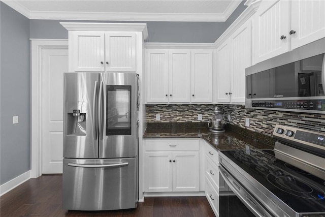 kitchen featuring stainless steel appliances, decorative backsplash, baseboards, white cabinetry, and dark wood finished floors