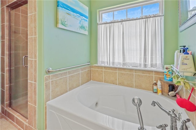 bathroom featuring a bath and a stall shower