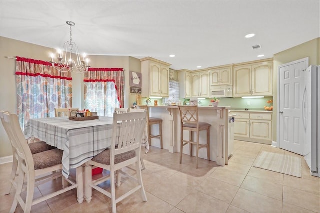 dining space with light tile patterned floors, visible vents, a notable chandelier, and recessed lighting