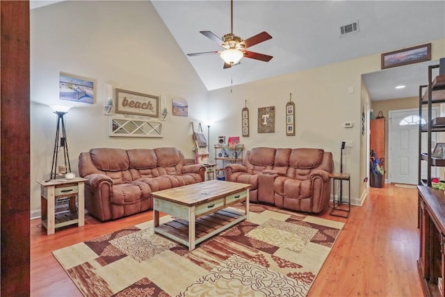 living area with visible vents, baseboards, ceiling fan, wood finished floors, and high vaulted ceiling