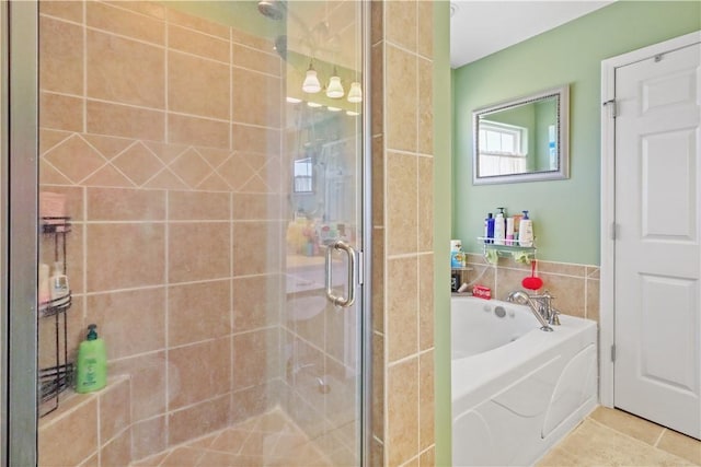 full bath featuring a bath, a shower stall, tile patterned floors, and tile walls