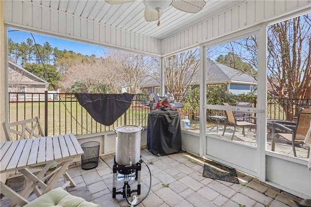 sunroom with plenty of natural light and ceiling fan