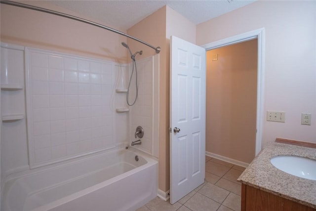 bathroom with a textured ceiling, washtub / shower combination, tile patterned flooring, baseboards, and vanity