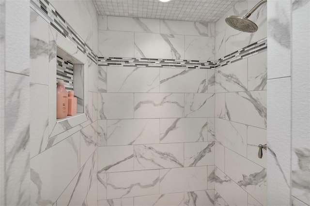 bathroom with a tile shower