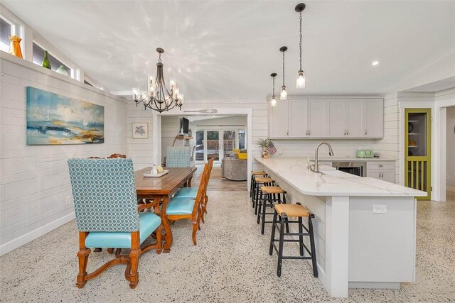 dining space featuring sink and vaulted ceiling