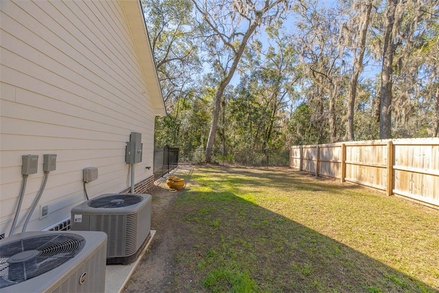 view of yard with cooling unit and a fenced backyard