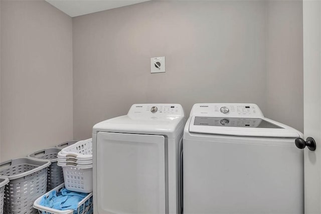 clothes washing area featuring laundry area and washer and dryer