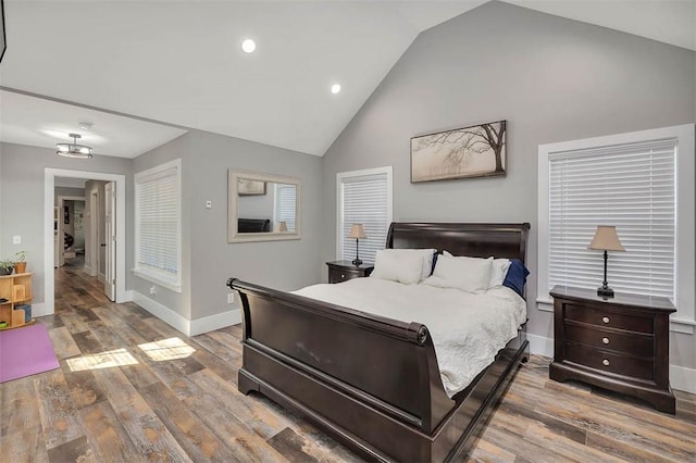 bedroom featuring recessed lighting, wood finished floors, baseboards, and high vaulted ceiling