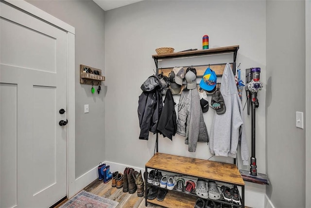 mudroom featuring baseboards and wood finished floors