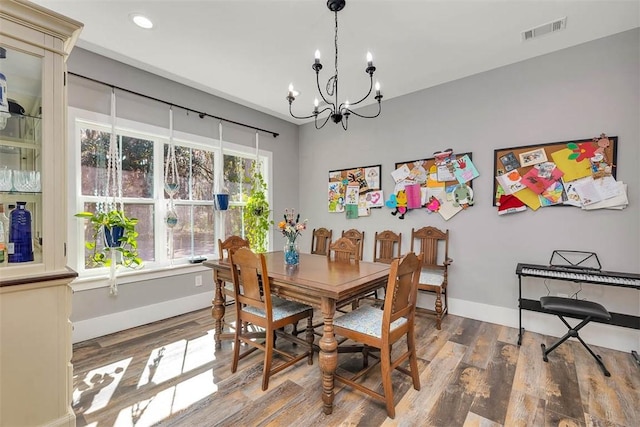 dining area featuring visible vents, wood finished floors, recessed lighting, an inviting chandelier, and baseboards