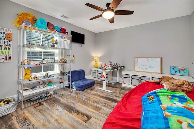 recreation room with visible vents, baseboards, ceiling fan, and wood finished floors