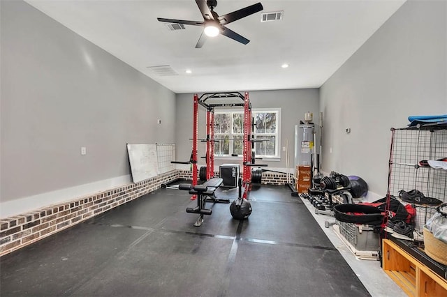 workout area featuring a ceiling fan, recessed lighting, visible vents, and water heater