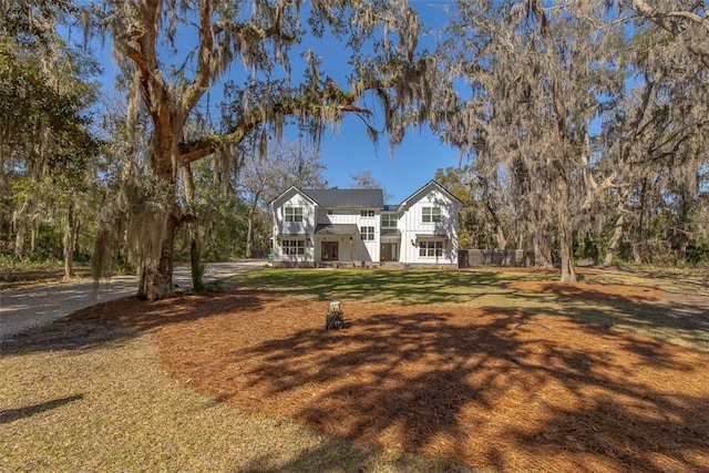 view of front of home featuring a front yard, fence, and board and batten siding