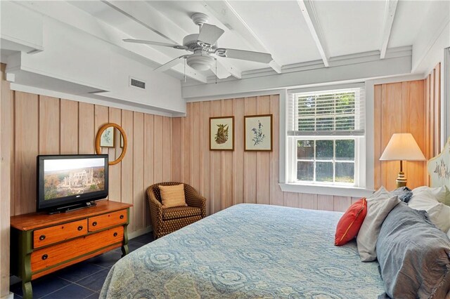 tiled bedroom with ceiling fan, wooden walls, and lofted ceiling with beams