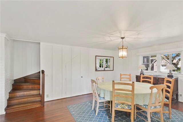 dining area with dark hardwood / wood-style floors and ornamental molding