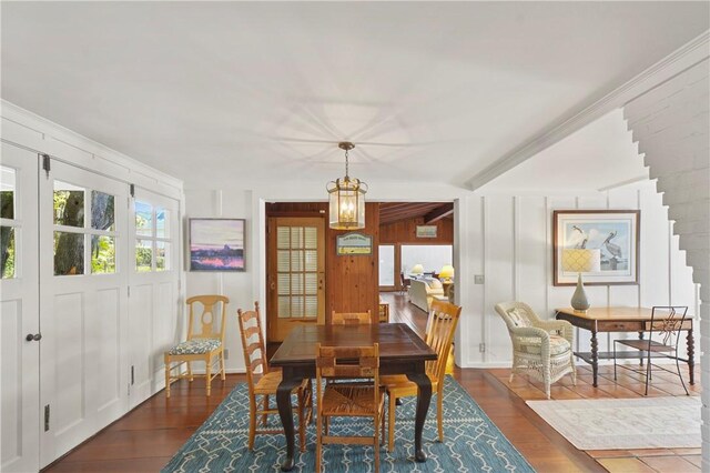 dining area featuring an inviting chandelier and dark wood-type flooring