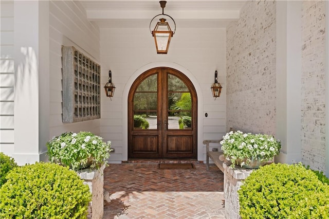 entrance to property with covered porch and french doors