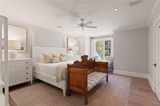 bedroom featuring ceiling fan, crown molding, and dark hardwood / wood-style floors