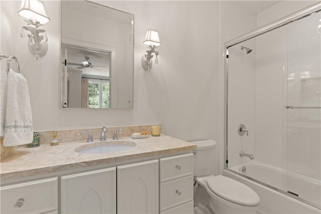 full bathroom with ceiling fan, toilet, vanity, and combined bath / shower with glass door