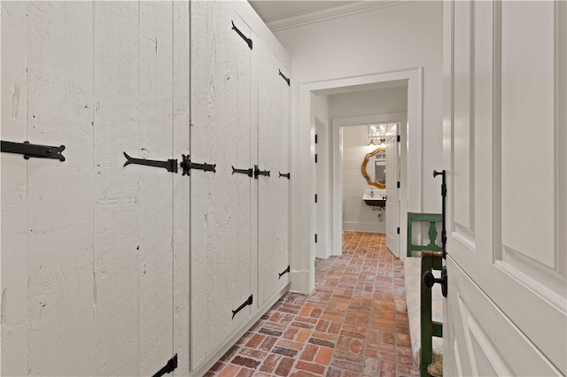 hallway featuring ornamental molding