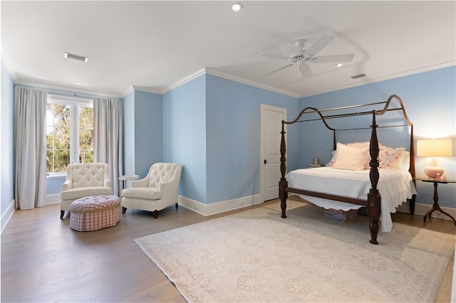 bedroom featuring hardwood / wood-style floors, ceiling fan, and ornamental molding