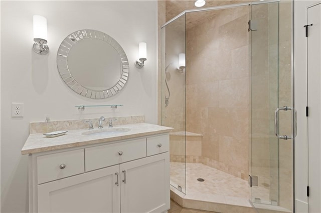 bathroom featuring vanity and a shower with door