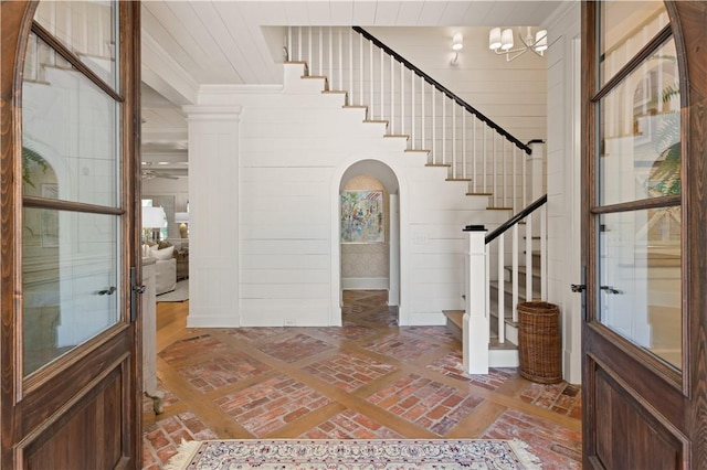 foyer entrance with wooden walls