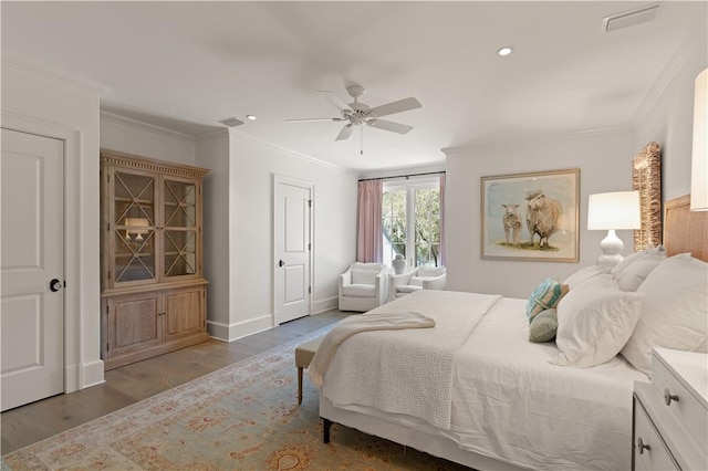 bedroom featuring ceiling fan, light hardwood / wood-style flooring, and crown molding