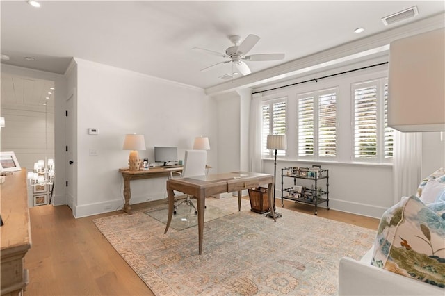 home office with crown molding, light hardwood / wood-style flooring, and ceiling fan