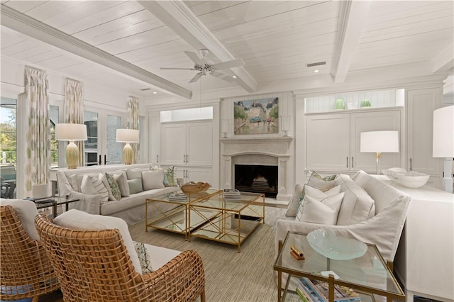 living room featuring beam ceiling, ceiling fan, and light wood-type flooring