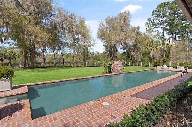 view of pool with a lawn