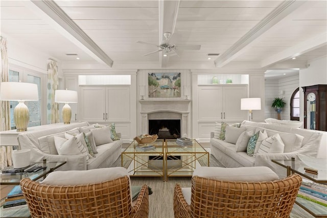 living room with beamed ceiling, hardwood / wood-style flooring, and ceiling fan