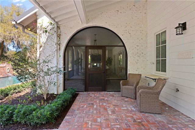 property entrance featuring a patio area