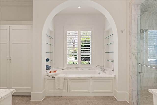 bathroom with tile patterned floors, independent shower and bath, and ornamental molding