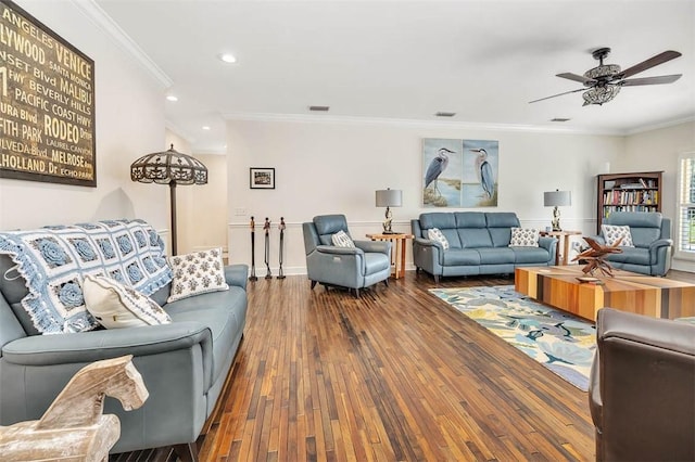 living room featuring hardwood / wood-style flooring, ceiling fan, and crown molding