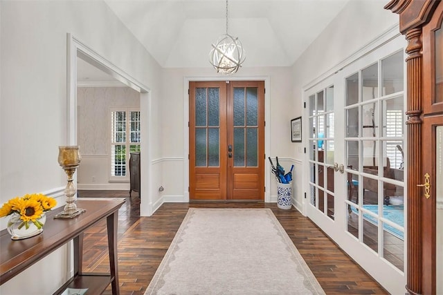 foyer featuring vaulted ceiling, dark hardwood / wood-style flooring, and french doors