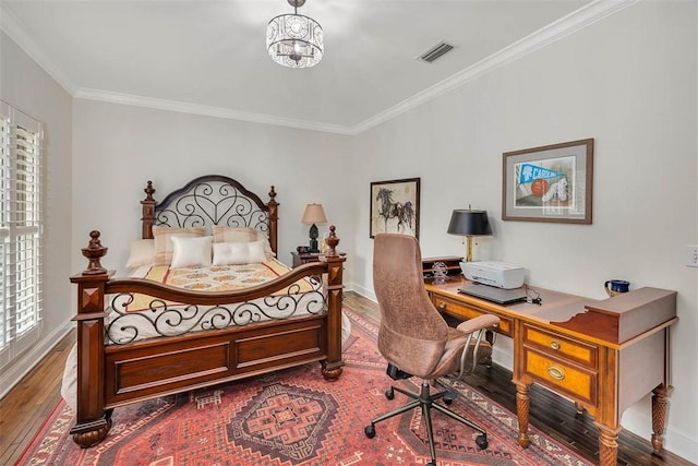 bedroom with a chandelier, hardwood / wood-style floors, and crown molding