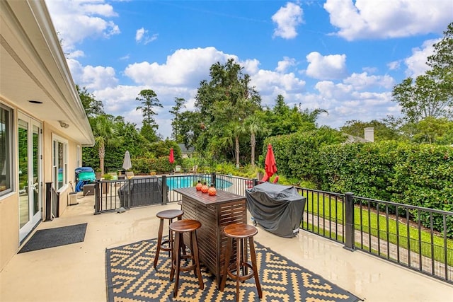 view of patio with a fenced in pool