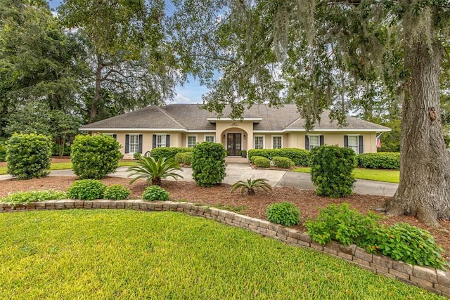 single story home with a front yard and french doors