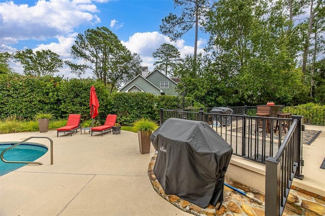 view of patio / terrace featuring a fenced in pool and grilling area