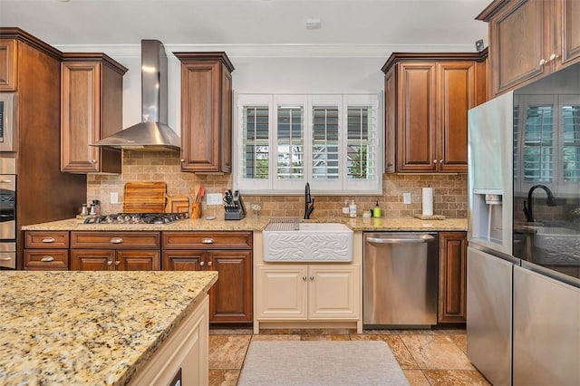 kitchen featuring light stone countertops, sink, wall chimney exhaust hood, tasteful backsplash, and appliances with stainless steel finishes