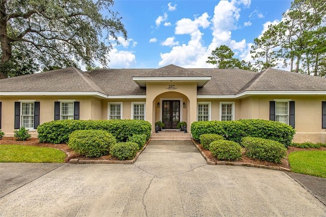 ranch-style house featuring french doors