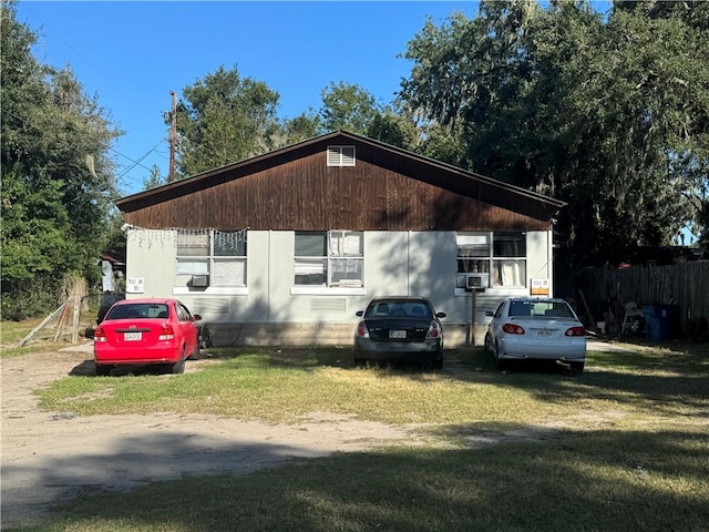 view of side of home with a lawn