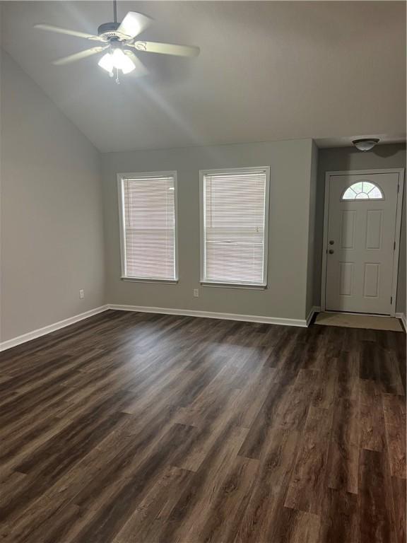 entryway featuring lofted ceiling, dark hardwood / wood-style floors, and ceiling fan