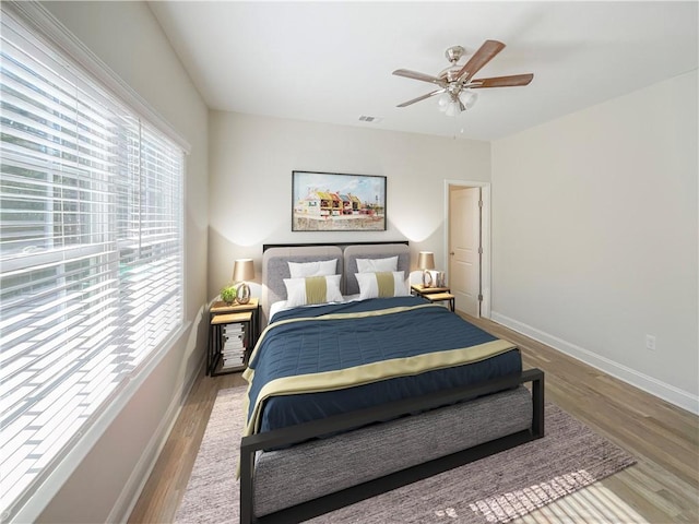 bedroom with ceiling fan and light hardwood / wood-style flooring