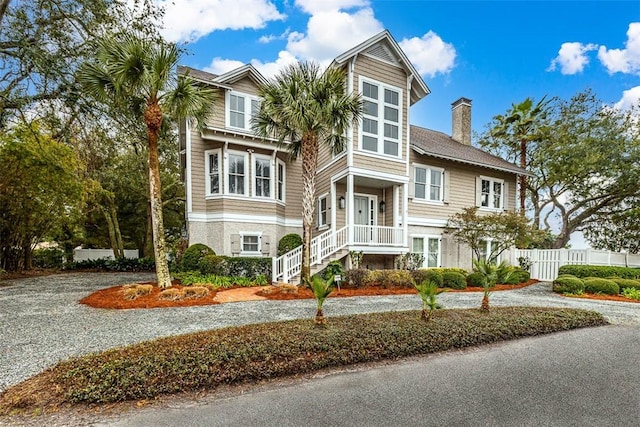 view of front of house featuring fence and a chimney