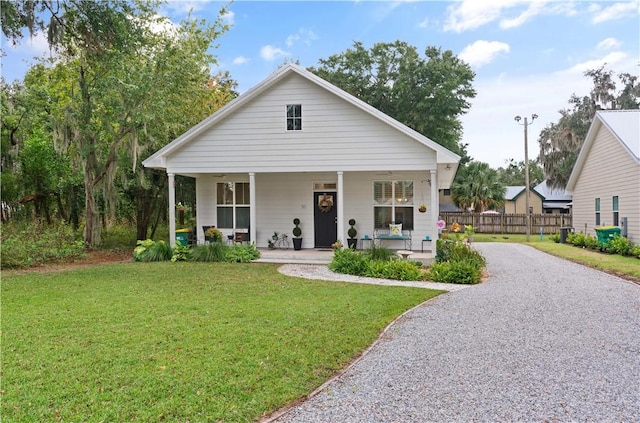 bungalow-style home with covered porch and a front yard