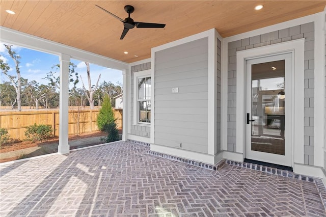 view of exterior entry with a patio and ceiling fan