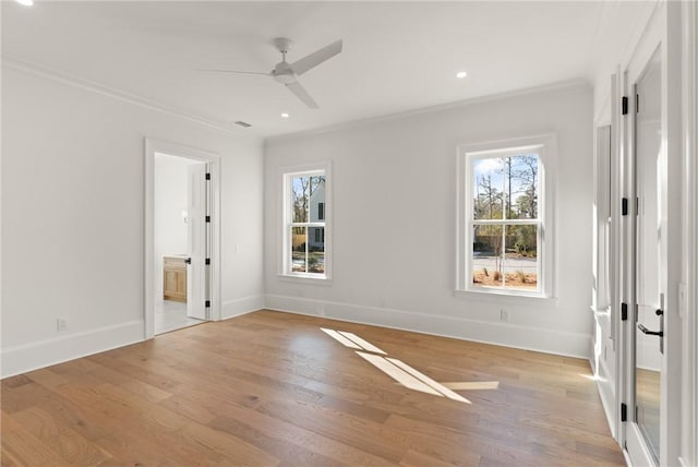 spare room featuring crown molding, ceiling fan, light hardwood / wood-style flooring, and a wealth of natural light