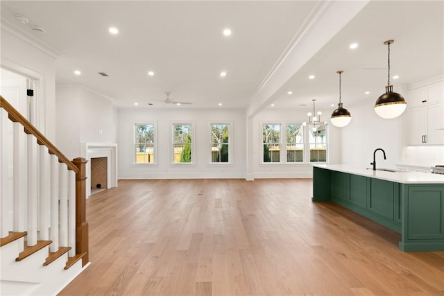 interior space with crown molding, a large island, and a healthy amount of sunlight